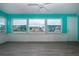 Bright sunroom with teal walls and wood-look floors at 1205 Chevy Chase Dr, Sun City Center, FL 33573