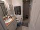 Well-lit bathroom with shower and granite countertop at 12500 Capri Cir N # 302, Treasure Island, FL 33706