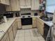 Galley kitchen with electric range and wood cabinets at 12500 Capri Cir N # 302, Treasure Island, FL 33706