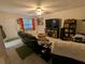 Living room with comfortable seating and large TV at 12500 Capri Cir N # 302, Treasure Island, FL 33706