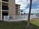 Community pool area with white fence and landscaping at 12500 Capri Cir N # 302, Treasure Island, FL 33706