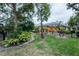 Landscaped backyard with pool and screened enclosure at 16312 Dunlindale Dr, Lithia, FL 33547