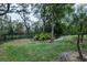 Landscaped backyard with mature trees and a fence at 16312 Dunlindale Dr, Lithia, FL 33547