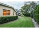 Landscaped backyard with lush greenery and a paved pathway at 16312 Dunlindale Dr, Lithia, FL 33547