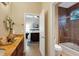 Elegant bathroom with double sinks, granite countertop, and a large walk-in shower at 16312 Dunlindale Dr, Lithia, FL 33547