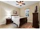 Bright bedroom featuring a comfortable sleigh bed, nightstand, and ceiling fan at 16312 Dunlindale Dr, Lithia, FL 33547