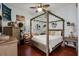 Charming bedroom with canopy bed and wood floors at 16312 Dunlindale Dr, Lithia, FL 33547