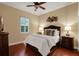 Comfortable bedroom with a queen-size bed and wood floors at 16312 Dunlindale Dr, Lithia, FL 33547