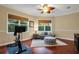 Home exercise room with a stationary bike and comfortable seating area at 16312 Dunlindale Dr, Lithia, FL 33547