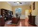 Spacious home office with built-in wooden bookcases and a large desk at 16312 Dunlindale Dr, Lithia, FL 33547