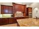 Gourmet kitchen with granite countertops and dark wood cabinetry at 16312 Dunlindale Dr, Lithia, FL 33547