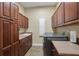 Well-equipped laundry room with ample cabinetry and countertop space at 16312 Dunlindale Dr, Lithia, FL 33547