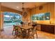 Outdoor kitchen and dining area with a stone fireplace and pool view at 16312 Dunlindale Dr, Lithia, FL 33547
