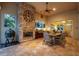 Outdoor kitchen with stone fireplace, built-in grill, and dining area at 16312 Dunlindale Dr, Lithia, FL 33547