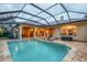 Resort-style pool with covered patio and adjacent spa at 16312 Dunlindale Dr, Lithia, FL 33547