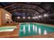 Inviting pool and spa at night with covered patio at 16312 Dunlindale Dr, Lithia, FL 33547