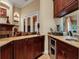 Convenient wet bar with wine cooler and granite countertop at 16312 Dunlindale Dr, Lithia, FL 33547