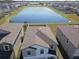 Aerial view of house and lake in a residential community at 16719 Delia St, Wimauma, FL 33598