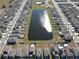 Aerial view of houses and lake in a community at 16719 Delia St, Wimauma, FL 33598