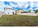 Large backyard with a fence and brown grass at 16719 Delia St, Wimauma, FL 33598