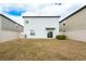 Large backyard with a fence and brown grass at 16719 Delia St, Wimauma, FL 33598