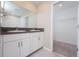 Double vanity bathroom with white cabinets and granite countertop at 16719 Delia St, Wimauma, FL 33598