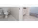 Clean bathroom with toilet, sink, and tiled floor at 16719 Delia St, Wimauma, FL 33598