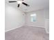 Spacious bedroom with neutral walls, ceiling fan, and carpet at 16719 Delia St, Wimauma, FL 33598