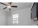 Bedroom with window, ceiling fan and neutral decor at 16719 Delia St, Wimauma, FL 33598