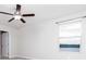 Bedroom with window, ceiling fan, and neutral walls at 16719 Delia St, Wimauma, FL 33598