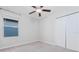 Well-lit bedroom with double door closet and ceiling fan at 16719 Delia St, Wimauma, FL 33598
