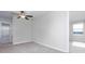 Bright bedroom with large window, ceiling fan and neutral decor at 16719 Delia St, Wimauma, FL 33598