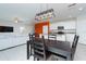 Open concept dining area with dark wood table and chairs, adjacent to kitchen at 16719 Delia St, Wimauma, FL 33598