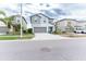Two-story house with gray siding, gray garage door and blue front door at 16719 Delia St, Wimauma, FL 33598