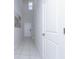 Clean and bright hallway with tile floor and white walls at 16719 Delia St, Wimauma, FL 33598