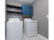 Laundry room featuring washer, dryer, and built-in shelving at 16719 Delia St, Wimauma, FL 33598