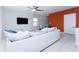 Spacious living room with light grey couch and blue accent chair at 16719 Delia St, Wimauma, FL 33598