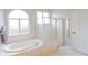 Bathroom with a garden tub, shower, and updated fixtures at 2015 Wexford Green Dr, Valrico, FL 33594