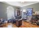 Home office with large desk, comfortable chairs, and built-in shelving at 2015 Wexford Green Dr, Valrico, FL 33594