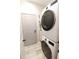 Modern laundry room with stackable washer and dryer at 2015 Wexford Green Dr, Valrico, FL 33594