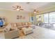 Open concept living room with sectional sofa and sliding doors to patio at 2015 Wexford Green Dr, Valrico, FL 33594