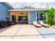 Spacious patio with seating and access to a pool and outdoor kitchen at 2015 Wexford Green Dr, Valrico, FL 33594
