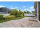Landscaped backyard with paver patio and privacy fence at 211 Shell Creek Ct, Apollo Beach, FL 33572