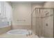 Bathroom with soaking tub, shower, and window at 211 Shell Creek Ct, Apollo Beach, FL 33572