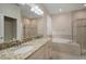 Double vanity bathroom with granite countertop and soaking tub at 211 Shell Creek Ct, Apollo Beach, FL 33572