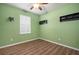 Bright bedroom with wood floors and ceiling fan at 211 Shell Creek Ct, Apollo Beach, FL 33572