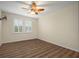 Bright bedroom with ceiling fan and wood-look floors at 211 Shell Creek Ct, Apollo Beach, FL 33572