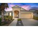 Beautiful two-story house with a landscaped yard, two-car garage, and walkway at 211 Shell Creek Ct, Apollo Beach, FL 33572