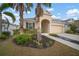 Attractive house with a landscaped yard, palm trees and a two-car garage at 211 Shell Creek Ct, Apollo Beach, FL 33572