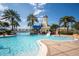 Community pool with waterslide, lighthouse, and palm trees at 211 Shell Creek Ct, Apollo Beach, FL 33572